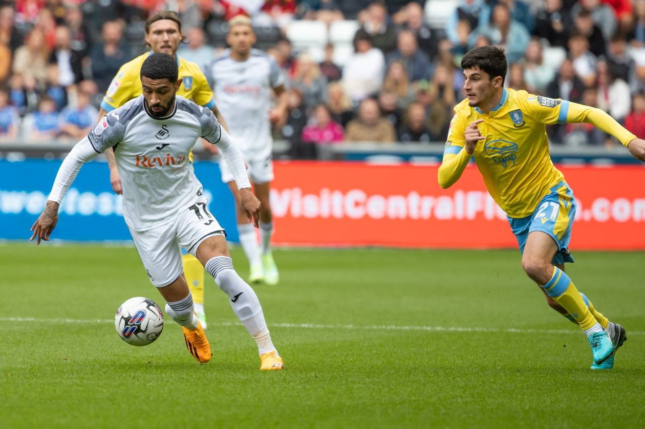 Josh Ginnelly driving forward with the ball for Swansea City