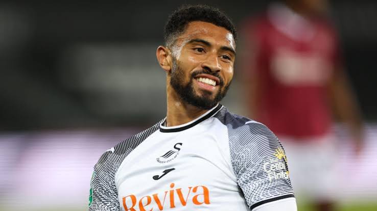 Josh Ginnelly smiling in a Swansea City shirt